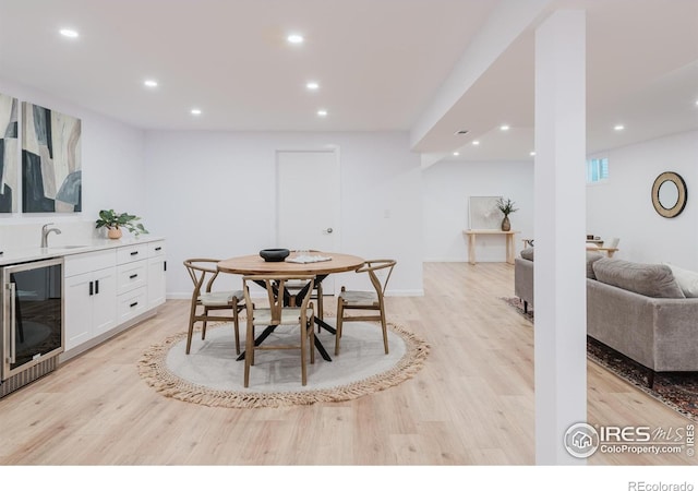 4601 S Lipan St, Englewood, CO 80110 - dining room featuring beverage cooler, light wood-style flooring, recessed lighting, bar area, and baseboards