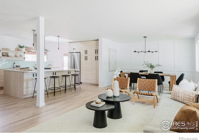 4601 S Lipan St, Englewood, CO 80110 - living room with light wood-style flooring and a chandelier