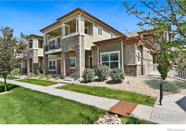 4902 Brookfield Dr Unit F, Fort Collins, CO 80528 - view of front facade with stone siding and a balcony