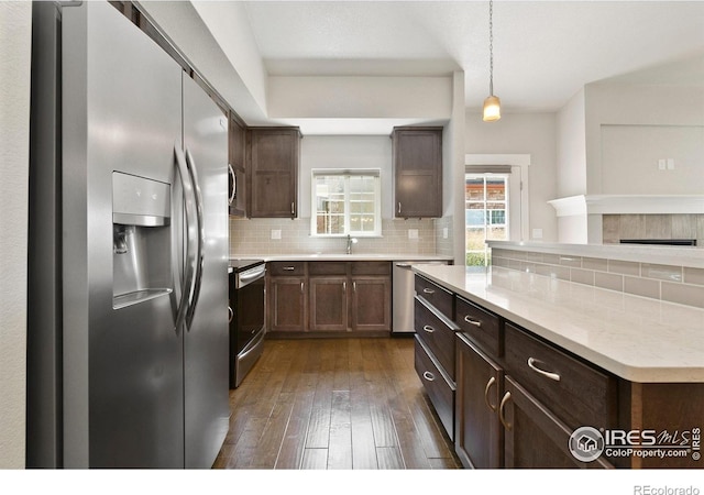 4902 Brookfield Dr Unit F, Fort Collins, CO 80528 - kitchen with appliances with stainless steel finishes, a sink, decorative backsplash, and dark wood-style floors
