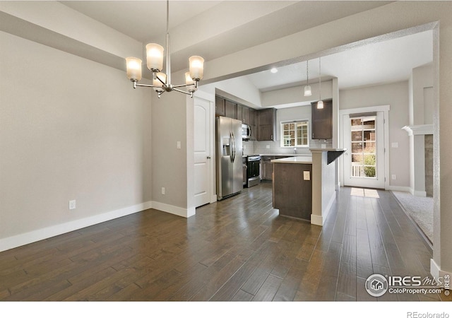 4902 Brookfield Dr Unit F, Fort Collins, CO 80528 - kitchen featuring stainless steel appliances, a chandelier, dark brown cabinets, light countertops, and dark wood finished floors