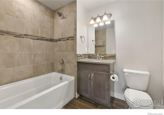 4902 Brookfield Dr Unit F, Fort Collins, CO 80528 - full bathroom with toilet, shower / tub combination, vanity, backsplash, and wood tiled floors