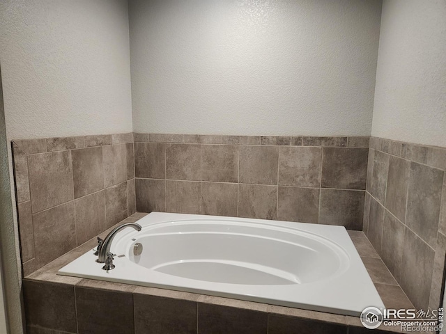 4902 Brookfield Dr Unit F, Fort Collins, CO 80528 - full bathroom with a garden tub and a textured wall