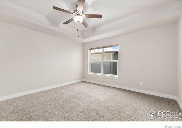 4902 Brookfield Dr Unit F, Fort Collins, CO 80528 - unfurnished room featuring carpet flooring, baseboards, ceiling fan, and a tray ceiling