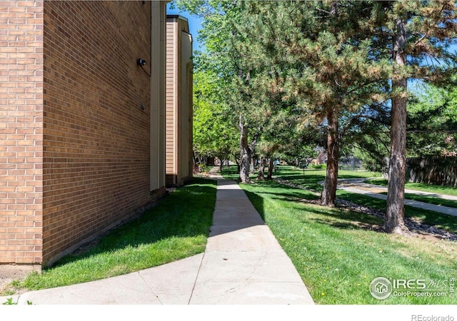 3313 Madison Ave Unit 212, Boulder, CO 80303 - view of property exterior with brick siding and a lawn