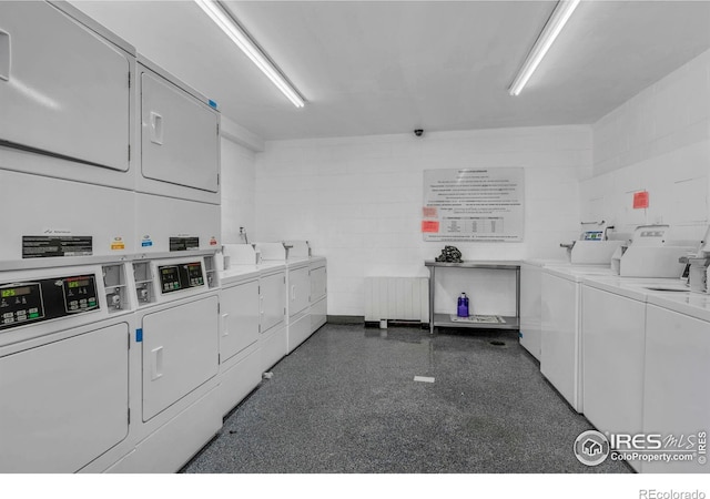 3313 Madison Ave Unit 212, Boulder, CO 80303 - shared laundry with washer and clothes dryer, stacked washing machine and dryer, and concrete block wall