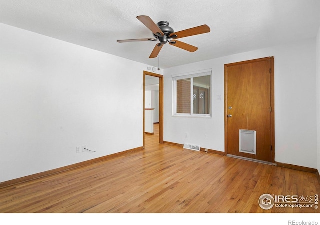 1229 Juniper St, Longmont, CO 80501 - empty room with light wood-style flooring, baseboards, ceiling fan, and heating unit