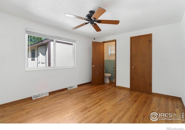 1229 Juniper St, Longmont, CO 80501 - unfurnished bedroom with light wood-style floors, baseboards, and ensuite bathroom
