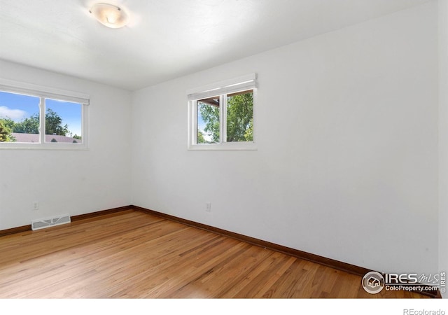 1229 Juniper St, Longmont, CO 80501 - spare room with baseboards and light wood-style flooring