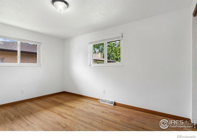 1229 Juniper St, Longmont, CO 80501 - spare room featuring light wood finished floors and baseboards