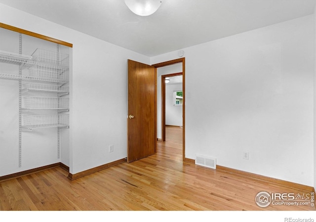 1229 Juniper St, Longmont, CO 80501 - unfurnished bedroom featuring light wood-style floors, a closet, and baseboards