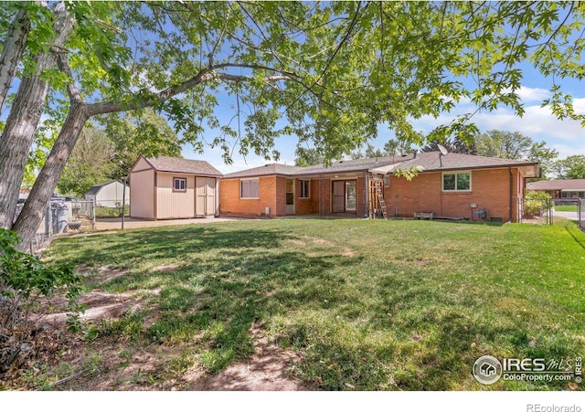 1229 Juniper St, Longmont, CO 80501 - back of house with a gate and brick siding