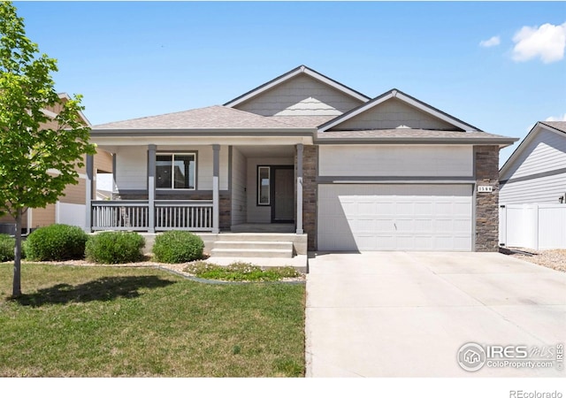1566 Driftline Dr, Severance, CO 80550 - view of front of property with an attached garage, concrete driveway, covered porch, and roof with shingles