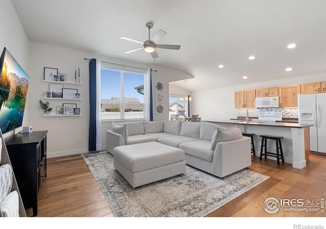 1566 Driftline Dr, Severance, CO 80550 - living area with recessed lighting, wood finished floors, a ceiling fan, baseboards, and a chandelier