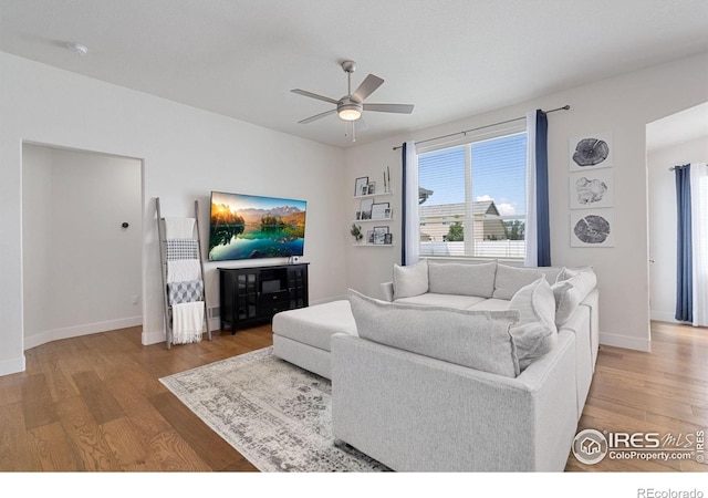 1566 Driftline Dr, Severance, CO 80550 - living area featuring ceiling fan, wood finished floors, and baseboards