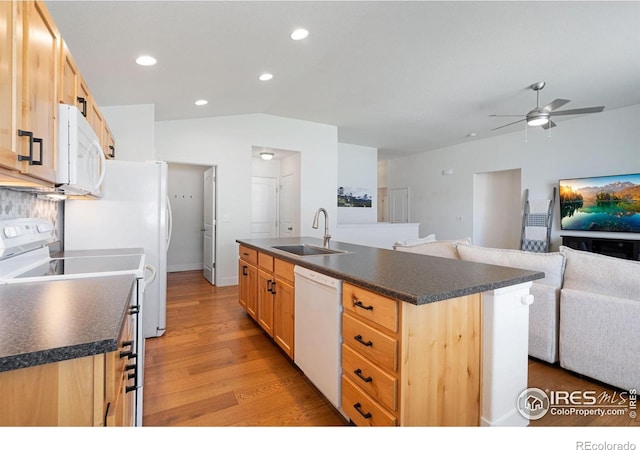 1566 Driftline Dr, Severance, CO 80550 - kitchen featuring white appliances, a sink, dark countertops, light wood finished floors, and open floor plan