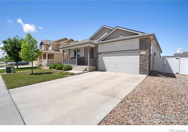 1566 Driftline Dr, Severance, CO 80550 - ranch-style house with a porch, an attached garage, driveway, a gate, and stone siding