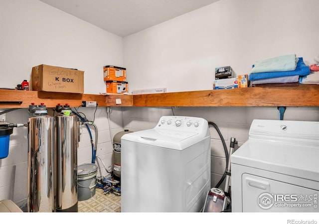 453 Black Fawn Ln, Westcliffe, CO 81252 - washroom featuring washing machine and clothes dryer and concrete block wall