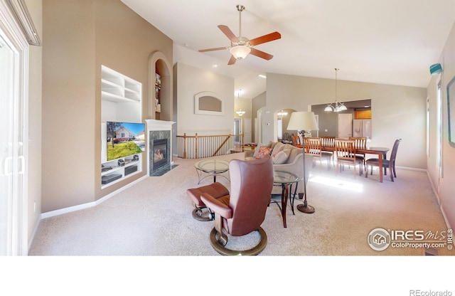8211 Lighthouse Lane Ct, Windsor, CO 80528 - living area with carpet floors, lofted ceiling, a ceiling fan, a tiled fireplace, and arched walkways