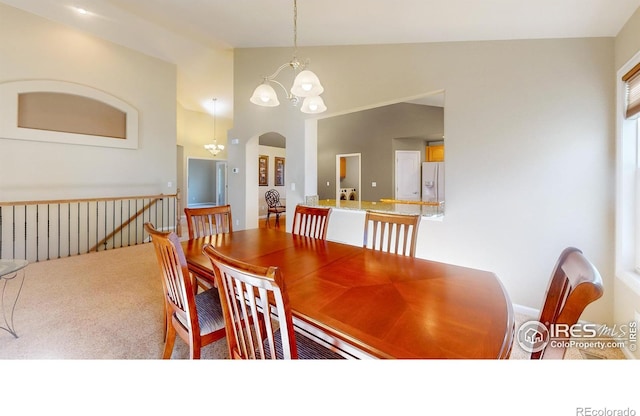 8211 Lighthouse Lane Ct, Windsor, CO 80528 - carpeted dining space featuring a chandelier, arched walkways, and high vaulted ceiling