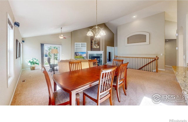 8211 Lighthouse Lane Ct, Windsor, CO 80528 - dining space featuring carpet flooring, a ceiling fan, a fireplace, baseboards, and high vaulted ceiling