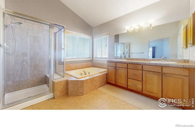 8211 Lighthouse Lane Ct, Windsor, CO 80528 - bathroom with double vanity, a shower stall, a bath, tile patterned flooring, and vaulted ceiling