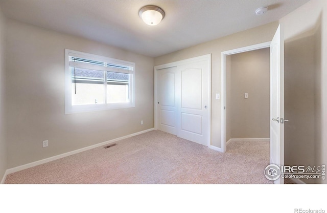 8211 Lighthouse Lane Ct, Windsor, CO 80528 - unfurnished bedroom with carpet, baseboards, and a closet