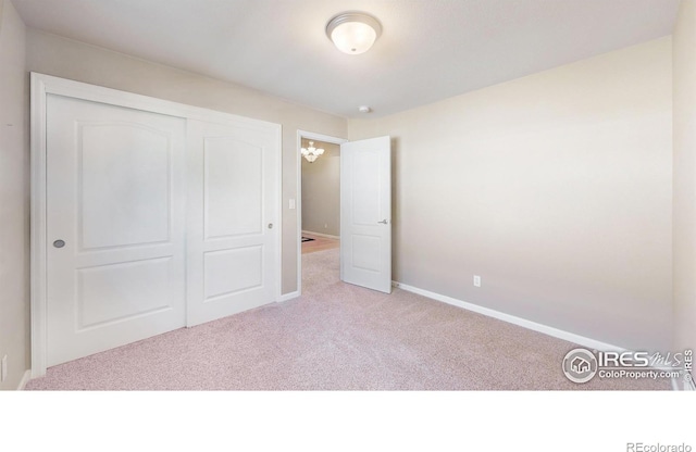 8211 Lighthouse Lane Ct, Windsor, CO 80528 - unfurnished bedroom with carpet flooring, baseboards, and a closet