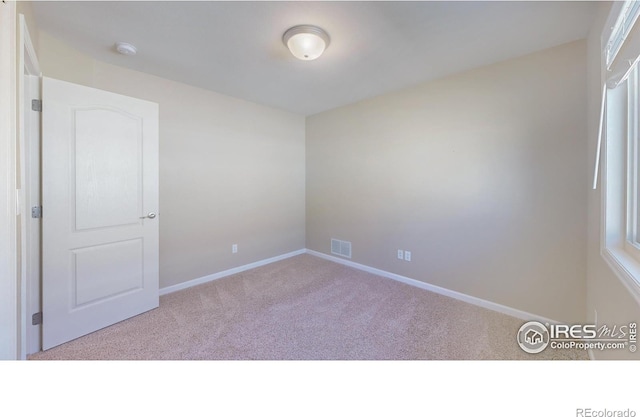 8211 Lighthouse Lane Ct, Windsor, CO 80528 - spare room with carpet flooring, a smoke detector, and baseboards