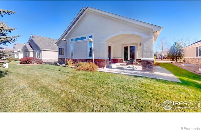 8211 Lighthouse Lane Ct, Windsor, CO 80528 - rear view of house featuring a patio area, a yard, stucco siding, and stone siding
