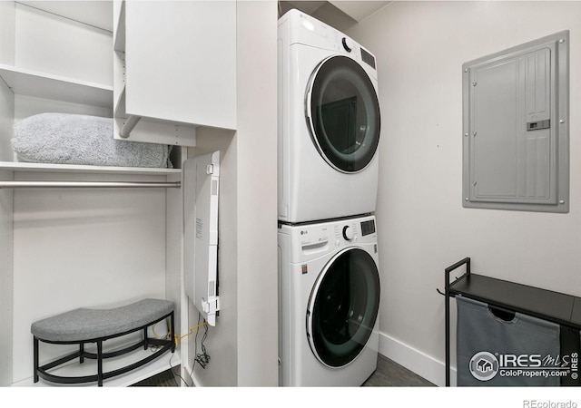 221 E Mountain Ave Unit 319, Fort Collins, CO 80524 - laundry room with stacked washer and clothes dryer, electric panel, and baseboards