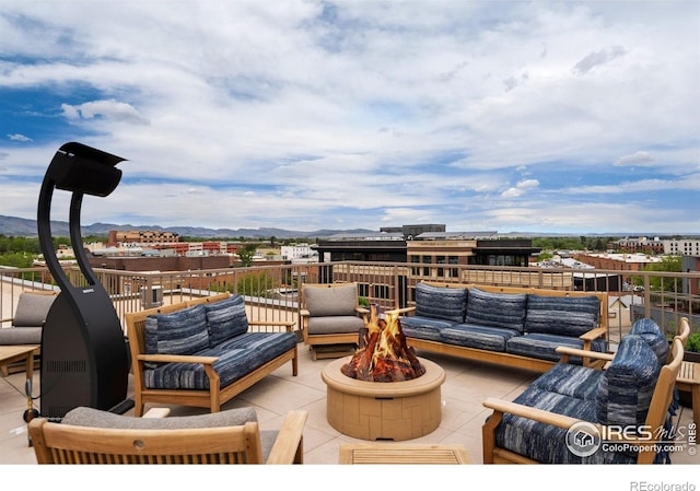 221 E Mountain Ave Unit 319, Fort Collins, CO 80524 - view of patio / terrace with an outdoor living space with a fire pit and a mountain view