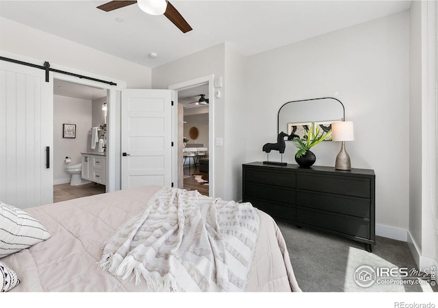 221 E Mountain Ave Unit 319, Fort Collins, CO 80524 - bedroom featuring a barn door, ensuite bathroom, baseboards, and a ceiling fan