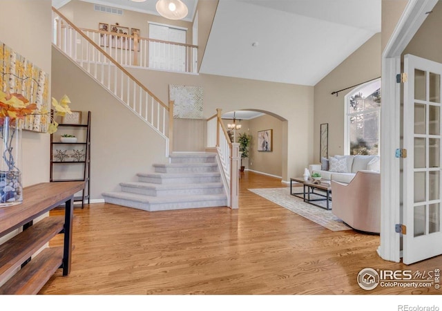 2841 Silver Pl, Superior, CO 80027 - foyer with stairs, high vaulted ceiling, arched walkways, wood finished floors, and baseboards