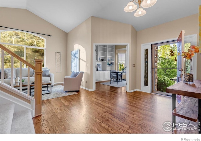 2841 Silver Pl, Superior, CO 80027 - entryway featuring a chandelier, stairway, wood finished floors, healthy amount of natural light, and high vaulted ceiling