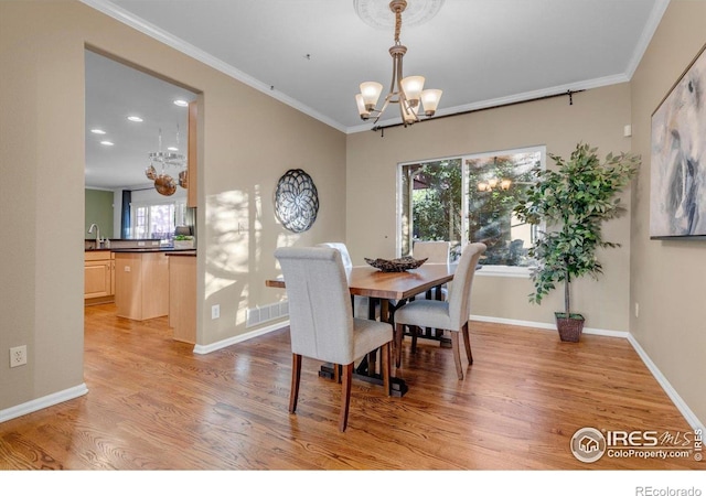2841 Silver Pl, Superior, CO 80027 - dining space featuring a chandelier, light wood finished floors, crown molding, baseboards, and recessed lighting