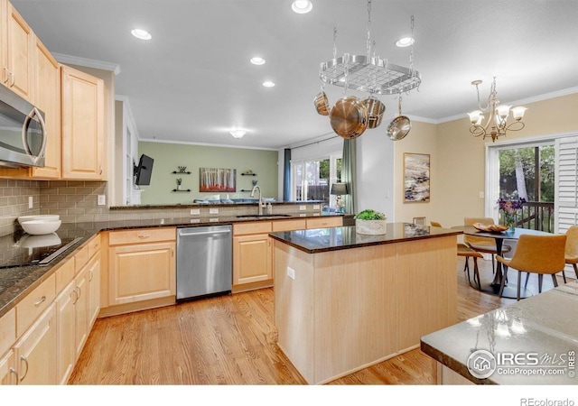 2841 Silver Pl, Superior, CO 80027 - kitchen with stainless steel appliances, light brown cabinets, a sink, ornamental molding, and plenty of natural light