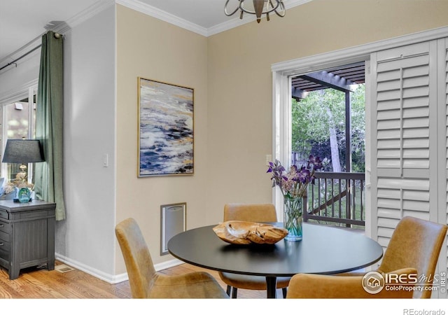 2841 Silver Pl, Superior, CO 80027 - dining area featuring light wood finished floors, baseboards, ornamental molding, and a chandelier