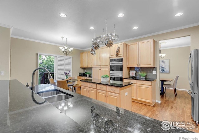 2841 Silver Pl, Superior, CO 80027 - kitchen featuring light brown cabinets, a sink, appliances with stainless steel finishes, a chandelier, and tasteful backsplash