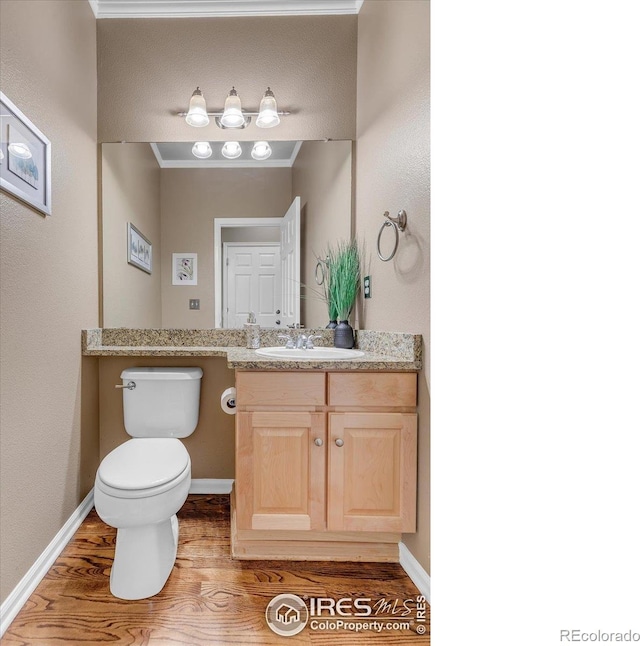 2841 Silver Pl, Superior, CO 80027 - bathroom featuring wood finished floors, vanity, toilet, and baseboards