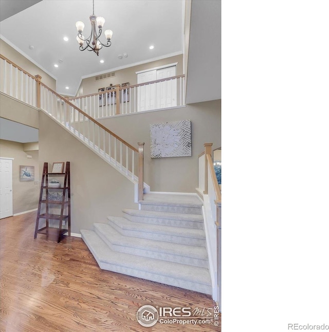 2841 Silver Pl, Superior, CO 80027 - stairway with ornamental molding, recessed lighting, a chandelier, baseboards, and wood finished floors