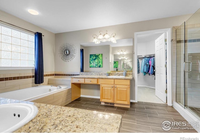 2841 Silver Pl, Superior, CO 80027 - full bathroom with vanity, a shower stall, a whirlpool tub, a spacious closet, and wood tiled floors