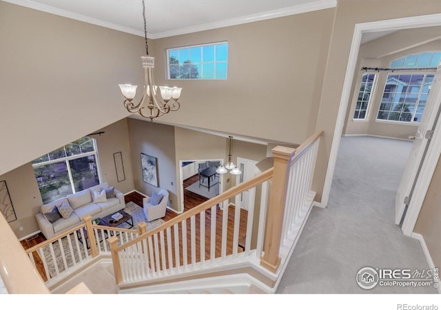 2841 Silver Pl, Superior, CO 80027 - stairway with a chandelier, baseboards, carpet floors, and crown molding
