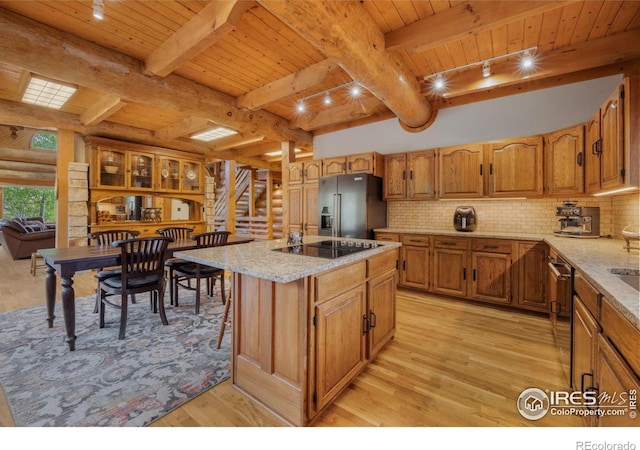 95 Choctaw Rd, Lyons, CO 80540 - kitchen with stainless steel appliances, wooden ceiling with exposed beams, light wood-type flooring, a center island, and brown cabinets