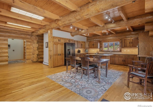 95 Choctaw Rd, Lyons, CO 80540 - dining room featuring light wood-style flooring, wood ceiling with exposed beams, and log walls