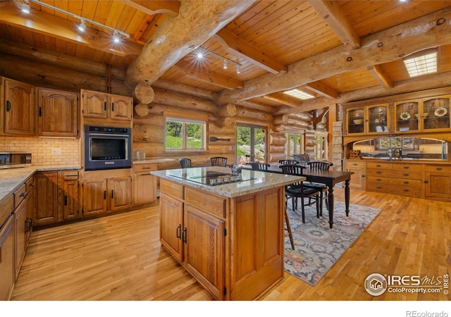 95 Choctaw Rd, Lyons, CO 80540 - kitchen featuring black appliances, wood ceiling with exposed beams, rustic walls, light wood-type flooring, and rail lighting