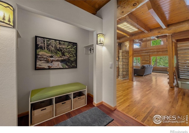 95 Choctaw Rd, Lyons, CO 80540 - hall with log walls, wood ceiling with exposed beams, wood finished floors, and baseboards
