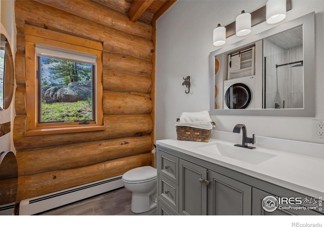 95 Choctaw Rd, Lyons, CO 80540 - full bath featuring log walls, baseboard heating, stacked washer / dryer, toilet, and vanity