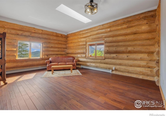 95 Choctaw Rd, Lyons, CO 80540 - living area with baseboard heating, a skylight, wood finished floors, plenty of natural light, and log walls