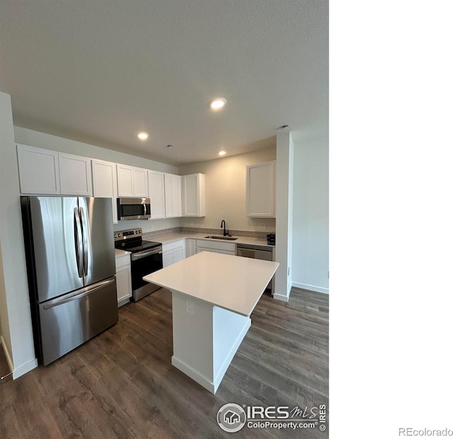 420 Condor Way, Johnstown, CO 80534 - kitchen featuring appliances with stainless steel finishes, a sink, white cabinets, light countertops, and dark wood-style flooring